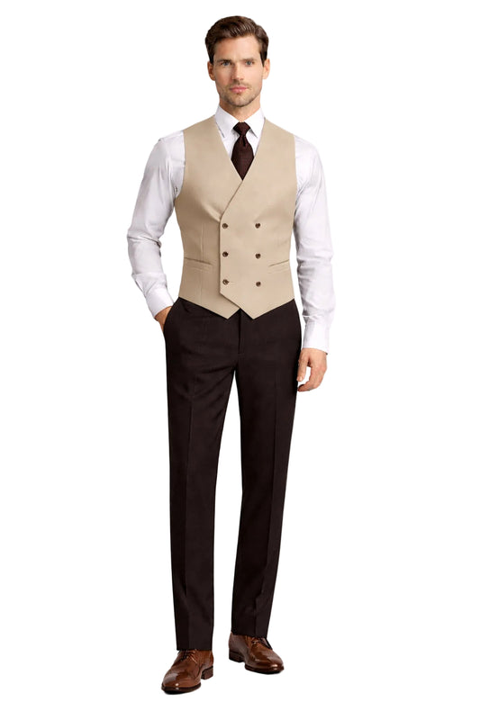 Man wearing a beige vest over a white shirt with a tie, black pants, and brown shoes on a white background.