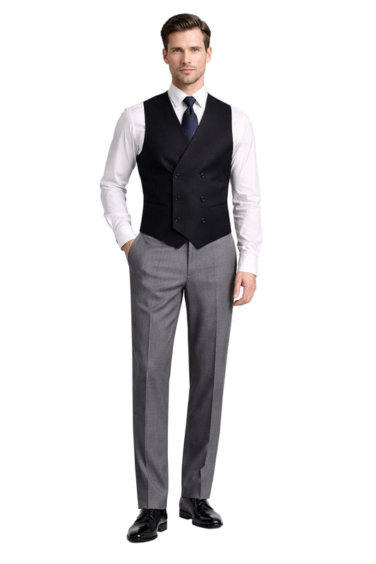 Man wearing a formal outfit with a vest, shirt, tie, and pants on a white background