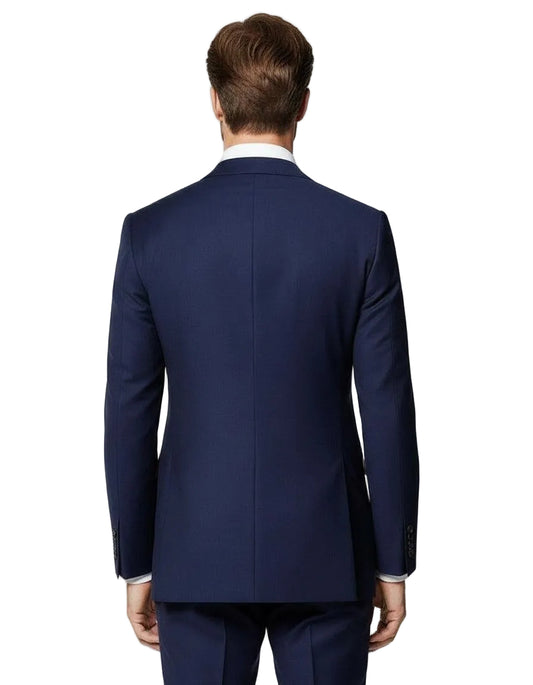 Man wearing a navy blue suit jacket on a light gray background