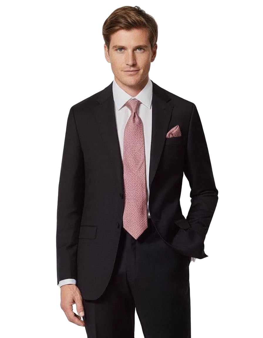 Man wearing a black suit with a pink tie and pocket square on a white background